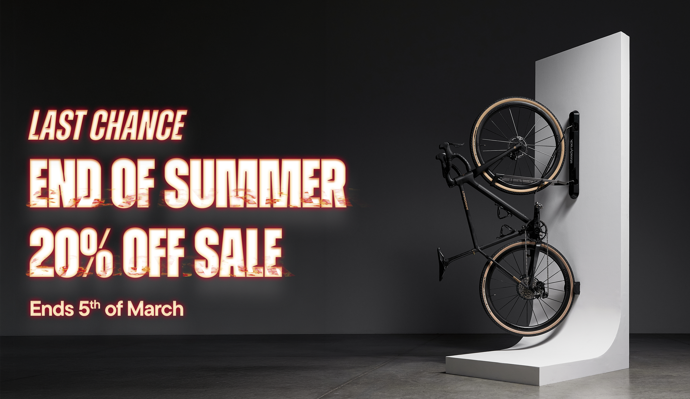 Bicycle on a stand with promotional text for a sale on a dark background